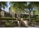 Grand home exterior with stone facade and lush landscaping at 19452 N 98Th Pl, Scottsdale, AZ 85255