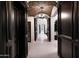 Elegant hallway with arched brick ceiling and dark wood doors at 19452 N 98Th Pl, Scottsdale, AZ 85255