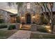 Elegant stone exterior with a charming entryway and landscaping at 19452 N 98Th Pl, Scottsdale, AZ 85255