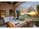 Relaxing covered patio with seating and sunset views at 19452 N 98Th Pl, Scottsdale, AZ 85255