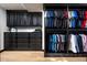 Spacious walk-in closet with custom built-ins and light wood floors at 19452 N 98Th Pl, Scottsdale, AZ 85255