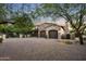 Two-car garage with brick driveway and landscaping at 19452 N 98Th Pl, Scottsdale, AZ 85255