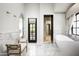 Luxurious bathroom with a freestanding tub and access to a private patio at 19452 N 98Th Pl, Scottsdale, AZ 85255