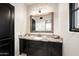 Bathroom with granite countertop, dark vanity, and large mirror at 19452 N 98Th Pl, Scottsdale, AZ 85255