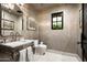 Elegant powder room features marble vanity and designer fixtures at 19452 N 98Th Pl, Scottsdale, AZ 85255