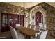 Outdoor dining area with stone accents and red doors at 19452 N 98Th Pl, Scottsdale, AZ 85255