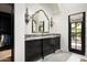 Modern bathroom with dark wood vanity and a view to a private courtyard at 19452 N 98Th Pl, Scottsdale, AZ 85255