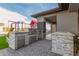 Outdoor kitchen with built-in grill and stone countertops at 12 E Quartz Rock Rd, Phoenix, AZ 85085