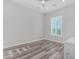 Simple bedroom with wood-look flooring and window with plantation shutters at 12 E Quartz Rock Rd, Phoenix, AZ 85085