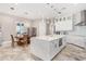 Open concept kitchen with white cabinets, quartz countertops, and stainless steel appliances at 12 E Quartz Rock Rd, Phoenix, AZ 85085