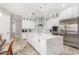 Modern white kitchen with stainless steel appliances and a large island at 12 E Quartz Rock Rd, Phoenix, AZ 85085