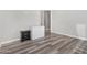 Empty bedroom with wood-look floors, a small nightstand, and a mini-fridge at 12 E Quartz Rock Rd, Phoenix, AZ 85085