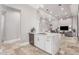 Modern kitchen with white cabinets, quartz countertops, and a breakfast bar at 12 E Quartz Rock Rd, Phoenix, AZ 85085