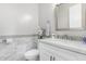 Modern bathroom with white vanity, marble tile, and a frameless mirror at 12 E Quartz Rock Rd, Phoenix, AZ 85085