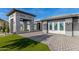 Modern home's entrance with stone archway and paver driveway at 12 E Quartz Rock Rd, Phoenix, AZ 85085