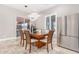 Bright dining area with a wood table and six chairs, stainless steel appliances, and tile floors at 12 E Quartz Rock Rd, Phoenix, AZ 85085
