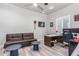 Home office with a couch, desk, and mini-fridge; ideal for work and relaxation at 12 E Quartz Rock Rd, Phoenix, AZ 85085