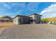 Modern two-car garage with dark gray doors and paver driveway at 12 E Quartz Rock Rd, Phoenix, AZ 85085