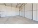 View of an empty garage space with concrete floor and extra storage at 6272 E 16Th Ave, Apache Junction, AZ 85119