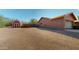 View of house exterior and a red shed in the backyard at 6272 E 16Th Ave, Apache Junction, AZ 85119