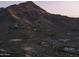 Aerial view showcasing a hillside community with custom homes and panoramic mountain views at 6041 E Foothill N Dr, Paradise Valley, AZ 85253
