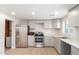 Modern kitchen featuring stainless steel appliances and gray cabinets at 9424 N 2Nd Pl, Phoenix, AZ 85020