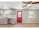 Bright kitchen with gray cabinets, red door, and wood-look flooring at 9424 N 2Nd Pl, Phoenix, AZ 85020
