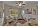 Living room with two armchairs, wood floors and large window at 42336 W North Star Dr, Maricopa, AZ 85138