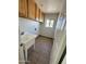 Laundry room with tile floor, sink, and cabinets at 860 W Hermosa Dr, Wickenburg, AZ 85390