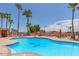 Inviting community pool with surrounding lounge chairs and palm trees at 11596 W Sierra Dawn Blvd # 196, Surprise, AZ 85378