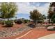 A serene walkway with a charming footbridge over a rock-filled stream at 11596 W Sierra Dawn Blvd # 196, Surprise, AZ 85378