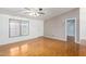 Living room featuring wood flooring, large windows and a ceiling fan at 11596 W Sierra Dawn Blvd # 196, Surprise, AZ 85378