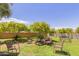 Relaxing community patio with benches, chairs, and shade trees at 11596 W Sierra Dawn Blvd # 196, Surprise, AZ 85378