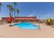 Community pool with a rose design and surrounding patio furniture at 11596 W Sierra Dawn Blvd # 196, Surprise, AZ 85378