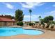Relaxing community pool and hot tub with plenty of lounge chairs at 11596 W Sierra Dawn Blvd # 196, Surprise, AZ 85378