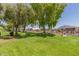 Landscaped green space with mature trees and a gated entrance at 11596 W Sierra Dawn Blvd # 196, Surprise, AZ 85378