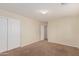 Simple bedroom with neutral walls, carpet, and double doors at 33025 N Mildred Ln, San Tan Valley, AZ 85144