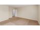 Simple bedroom with neutral walls, carpet, and an open door to another room at 33025 N Mildred Ln, San Tan Valley, AZ 85144