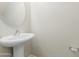 Bathroom with pedestal sink and round mirror at 33025 N Mildred Ln, San Tan Valley, AZ 85144