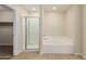 Bathroom with a shower, garden tub, and a large mirror at 33025 N Mildred Ln, San Tan Valley, AZ 85144