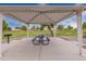 Park picnic area with table and grill under a covered pavilion at 33025 N Mildred Ln, San Tan Valley, AZ 85144