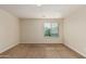 Bright bedroom with neutral walls and carpet, featuring a window with blinds at 33025 N Mildred Ln, San Tan Valley, AZ 85144