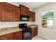 Kitchen with dark wood cabinets and granite countertops at 33025 N Mildred Ln, San Tan Valley, AZ 85144