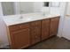 Bathroom with double vanity and wood cabinets at 43624 W Bailey Dr, Maricopa, AZ 85138