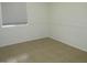 Bright bedroom featuring tile flooring and window at 43624 W Bailey Dr, Maricopa, AZ 85138