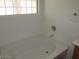 Bathroom with bathtub, shower, and a block window at 43624 W Bailey Dr, Maricopa, AZ 85138