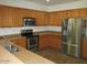 Kitchen with stainless steel appliances and wood cabinets at 43624 W Bailey Dr, Maricopa, AZ 85138