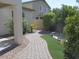 Landscaped backyard with brick paver pathway at 43624 W Bailey Dr, Maricopa, AZ 85138
