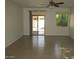 Spacious living room featuring tile floors and sliding glass doors at 43624 W Bailey Dr, Maricopa, AZ 85138