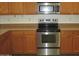 Stainless steel stove and microwave in kitchen at 43624 W Bailey Dr, Maricopa, AZ 85138